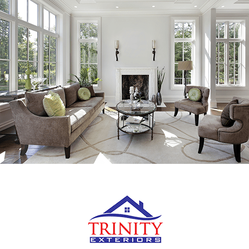 formal white living room with large multi-pane windows on every wall, with trinity exteriors logo